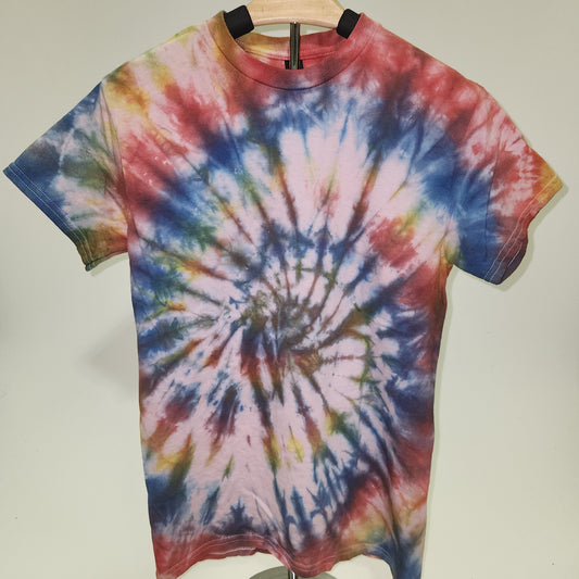 Tie-dye shirt on a hanger against a plain background