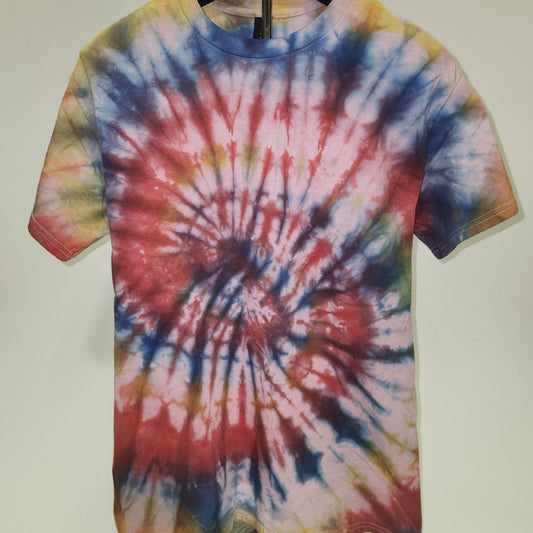 Tie-dye shirt with a spiral pattern on a plain background