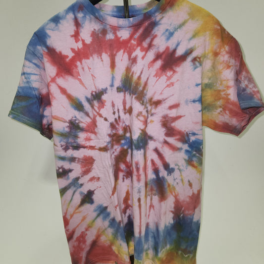 Tie-dye shirt on a hanger with a plain background