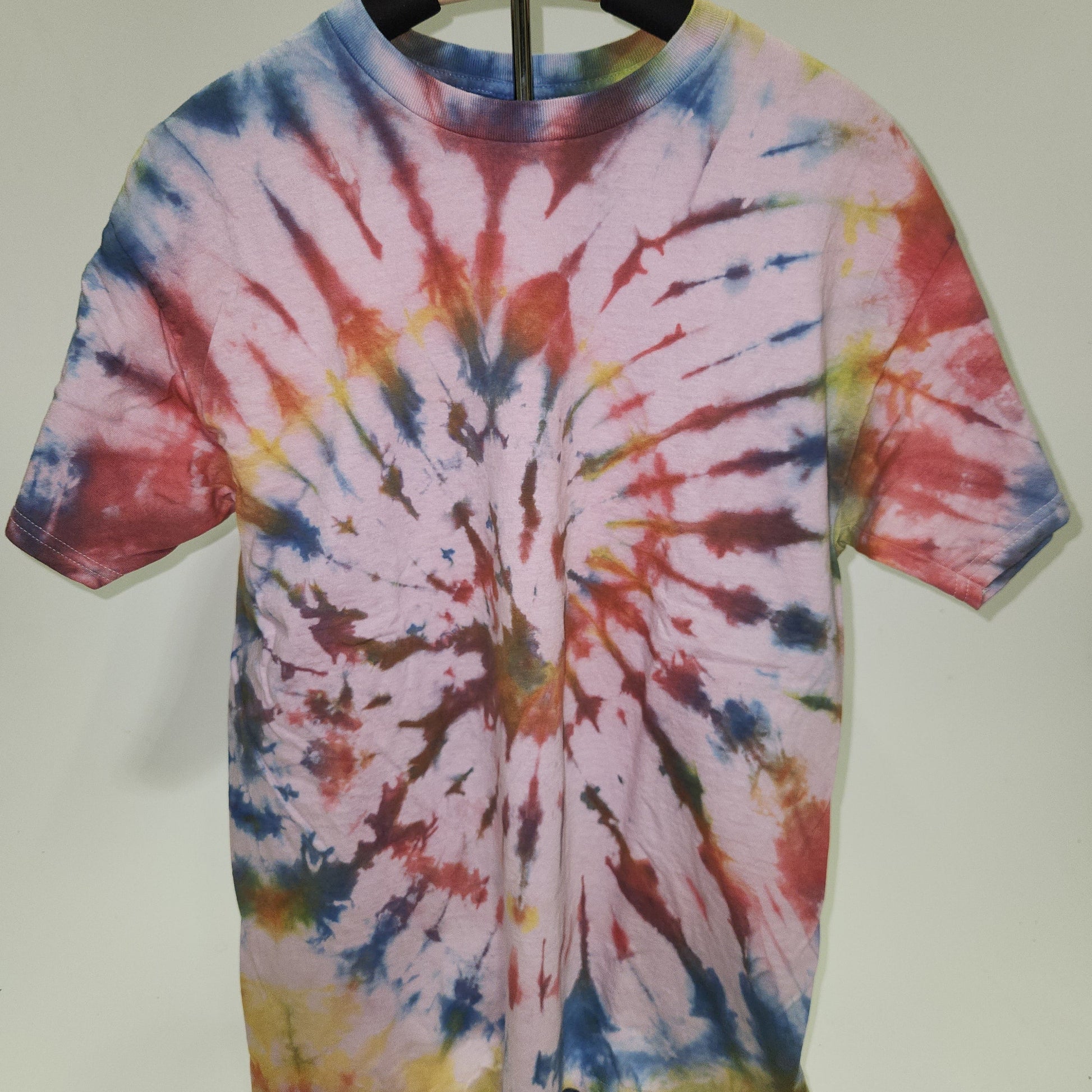Tie-dye short-sleeve shirt with a colorful spiral pattern on a white background