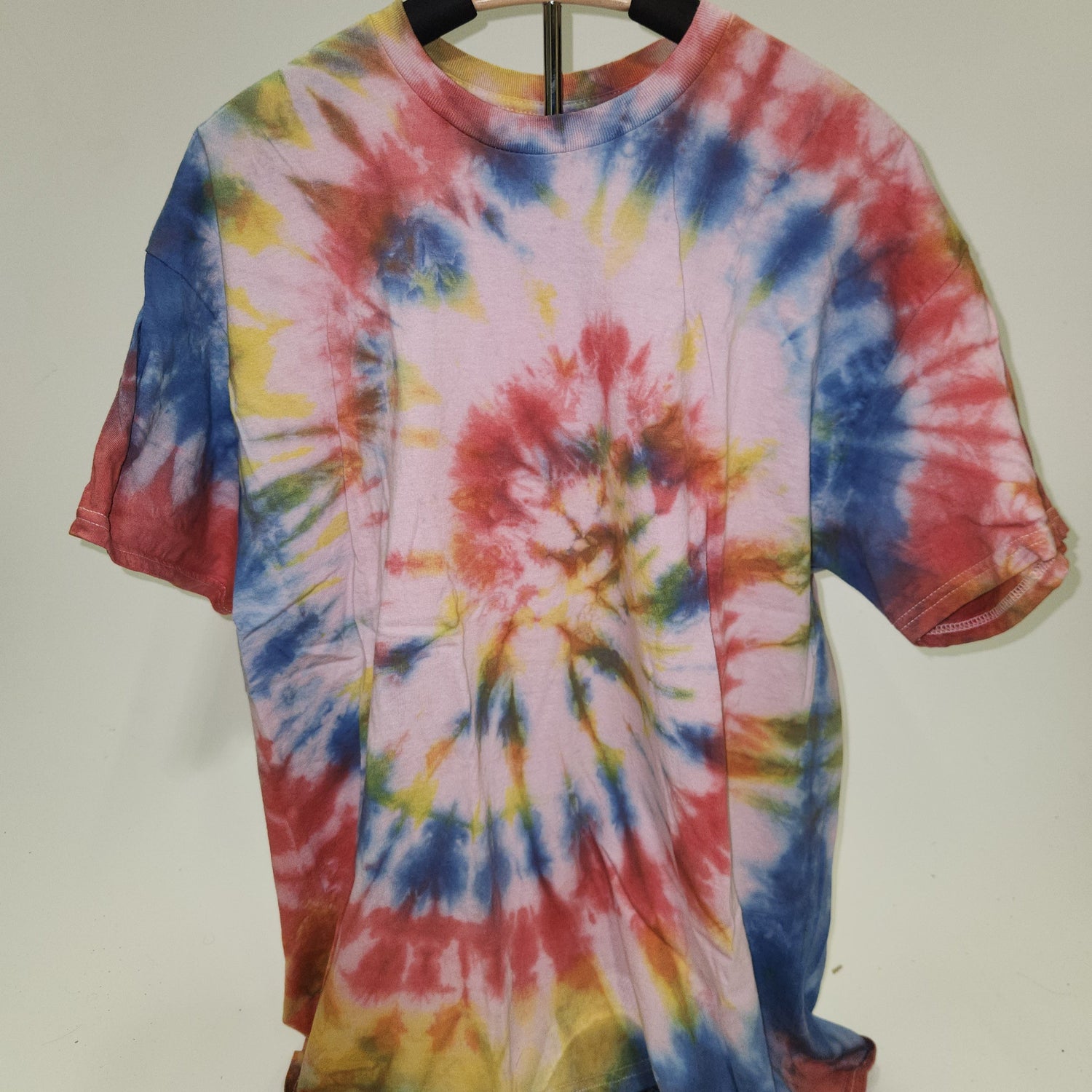 Colorful tie-dye shirt on a white background