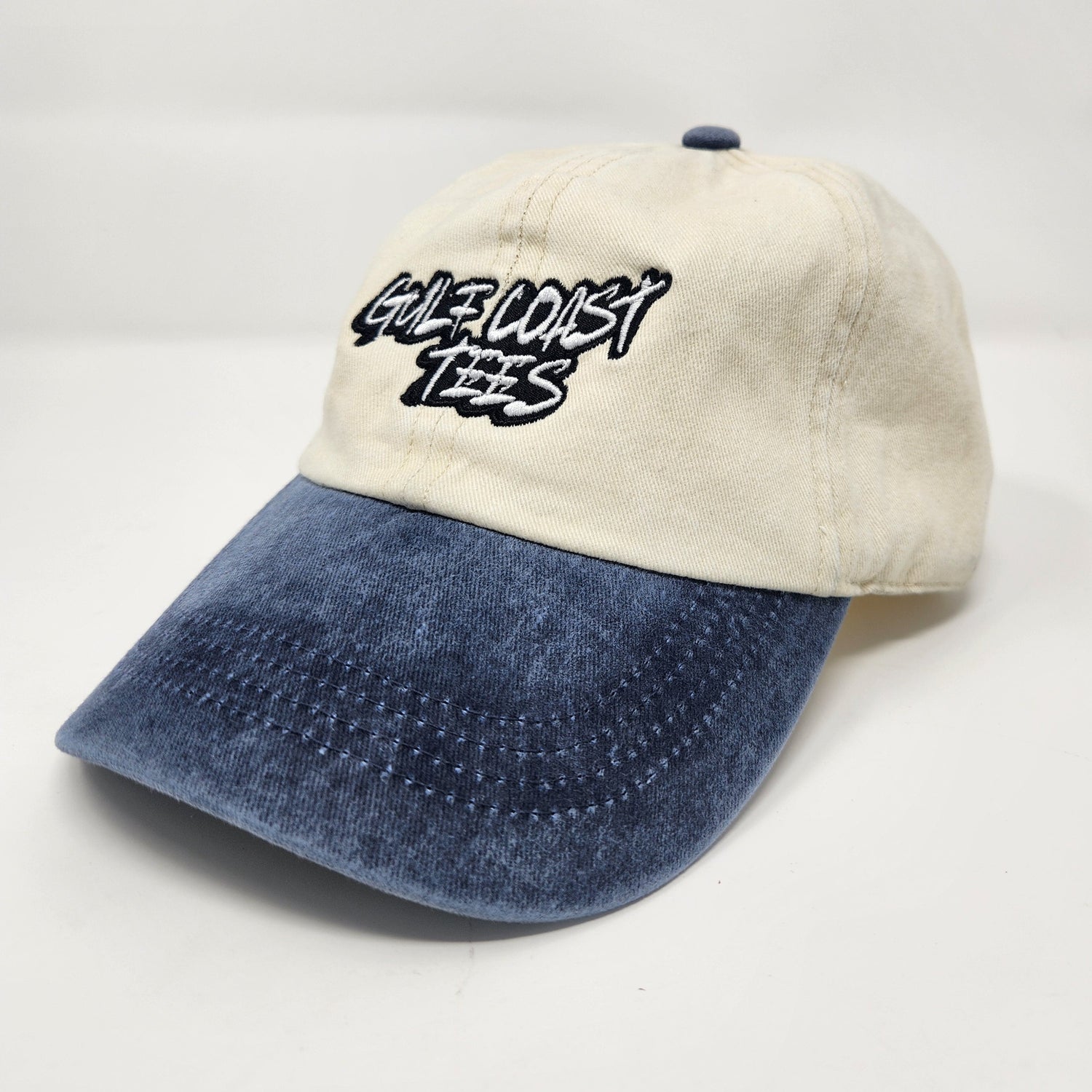 Two-tone cap with white and blue sections on a light gray background
